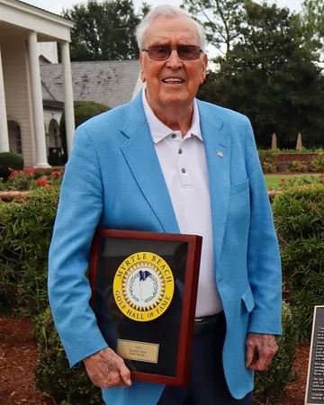Charlie Floyd with his induction plaque in the Hall of Fame garden at Pine Lakes.