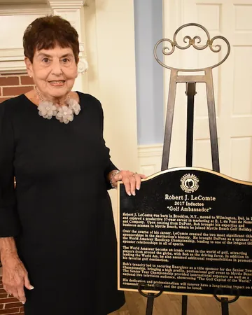 Marilyn LeComte with the plaque honoring her husband.
