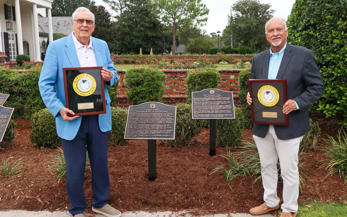 Charlie Floyd and Kevin Drum, on behalf of his father Bob Drum, with their Hall of Fame plaques